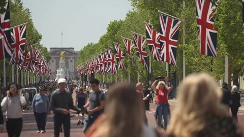 Mall aligned with Union Jack flags to Buckingham Palace, London, England Stock Footage 243079022