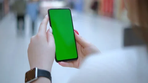 Mall. Beautiful Female using Mobile Phone. Back view of brunette holding chroma Stock Footage 232611965
