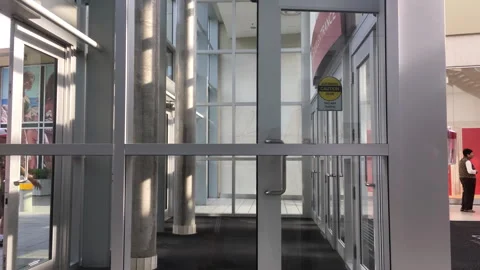 The mall entrance door automatically opens when customers go through Stock Footage 265969540