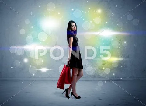 Mall lady with shopping bags and glitter light Stock Photos