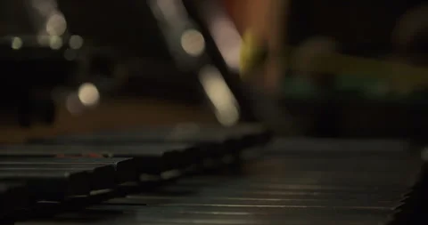 Mallet striking percussion bars in a dimly lit close-up Stock Footage 336470605
