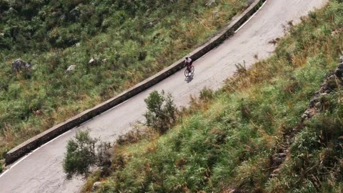 Mallorca cyclists navigate scenic winding roads. The zoomed camera Stock Footage 255545911