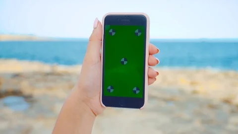 MALTA - JUNE 15, 2017: Close up woman holding smartphone with green screen Stock Footage 91225181