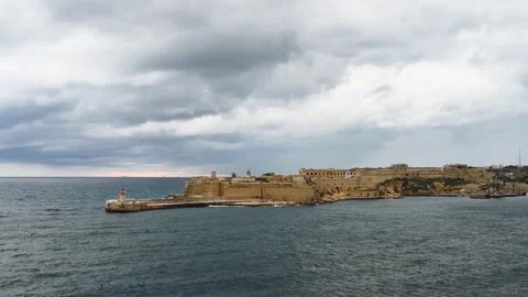 Maltese coast, lighthouse and shipping way to the port of Valleta Stock Footage