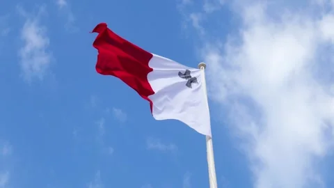 Maltese flag waves against a clear blue sky close up view of the red and white Stock Footage 341805919