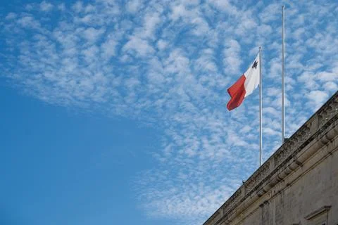 Maltese flag waves in the wind. Stock Photos