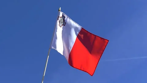 The Maltese flag waving in the wind in the blue sky Stock Footage 282432828