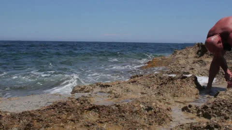 Maltese impressions - man looking for shellfish Stock Footage 25163527