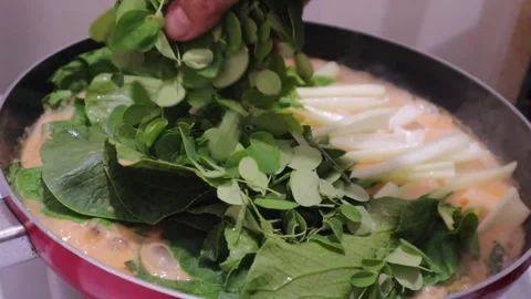 Malunggay leaves adding in the cooking pot Stock Footage 328013388