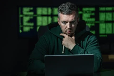 Malware hacker develops malicious software. Malware hacker infects computer Stock Photos
