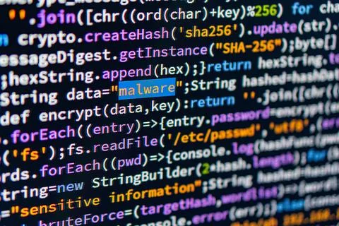 Malware. Image shows a close-up of computer screen displaying code with foc.. Stock Photos