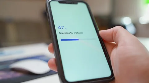 Malware scan progress on smartphone screen ends with threats found warning Stock Footage 342603095