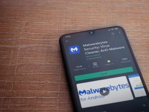 Malwarebytes Security app play store page on the display of a black mobile sm Stock Photos