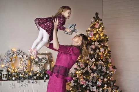 Mama throws up a small daughter on hands 9583. Stock Photos
