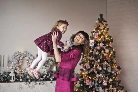 Mama throws up a small daughter on hands 9584. Stock Photos