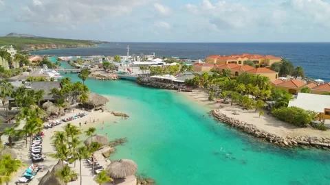 Mambo Beach flyover approaching Curacao Sea Aquarium with colorful tropical Vídeos de archivo 339110300