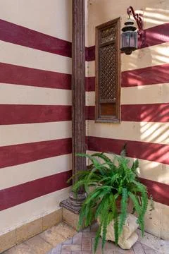 Mamluk architecture: rustic charm, weathered wooden window with star pattern Stock Photos
