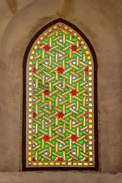 Mamluk era perforated stucco window with colorful stain glass with geometrical Stock Photos