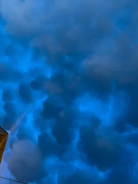 Mammatus clouds forming dramatic dark blue sky Stock Photos
