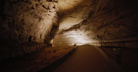 Mammoth Cave Hand Held Moving Shot inside Dimly Lit Large Corridor Stock Footage 99479981