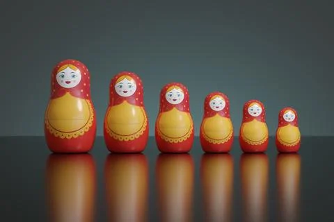 Mamushkas lined up side by side on a dark background. 3d illustration. Stock Photos