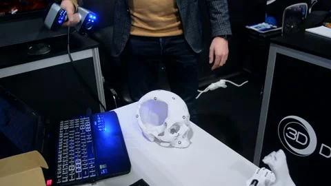 Man 3d scanner 3d scanning plastic prototype human skull printed on 3d printer Stock Footage 328909634