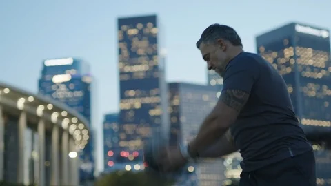 Man 50's working out on night streets in Downtown Los Angeles Stock Footage 103712132