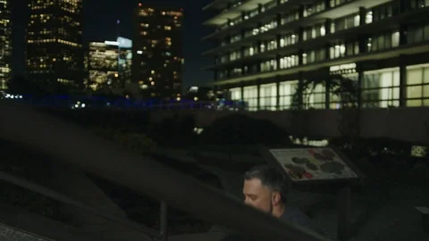 Man 50's working out on night streets in Downtown Los Angeles Stock Footage 103715792