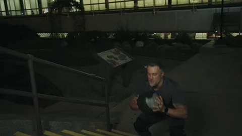 Man 50's working out on night streets in Downtown Los Angeles Stock Footage 103715985