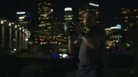 Man 50's working out on night streets in Downtown Los Angeles Stock Footage 103716956