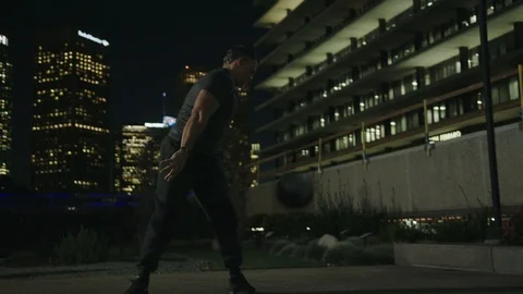 Man 50's working out on night streets in Downtown Los Angeles Video stock 103717786