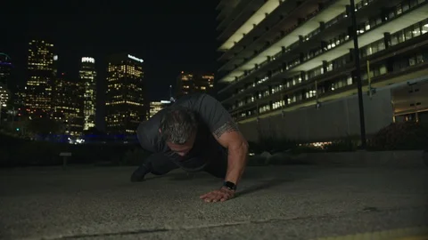 Man 50's working out on night streets in Downtown Los Angeles Stock Footage 103720246