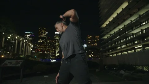Man 50's working out on night streets in Downtown Los Angeles Stock Footage 103720668