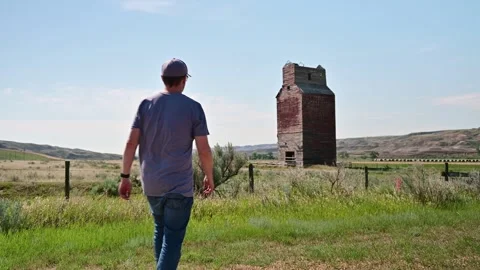 Man at an abandoned grain elevator, Dorothy, Alberta Stock Footage 244856007