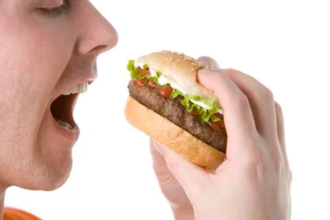 Man about to bite into a cheeseburger Stock Photos
