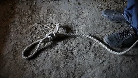 A man is about to commit suicide by hanging.A man ties a rope with a loop. Stock Footage 129022413