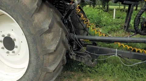 A man is about to sit in a big huge tires tractor Stock Footage 65219691
