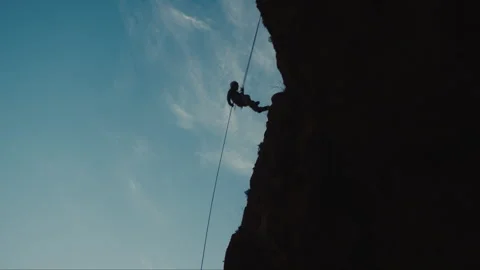 A Man Abseiling Down Cliff Stock Footage 275481392