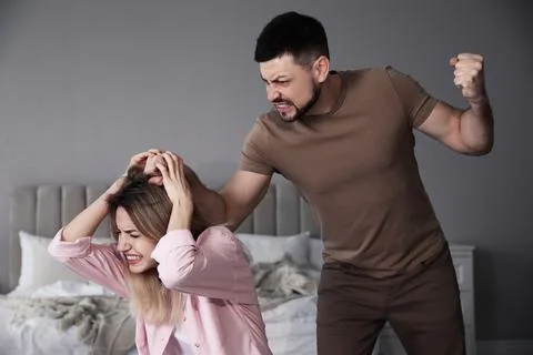 Man abusing scared woman at home. Domestic violence Stock Photos