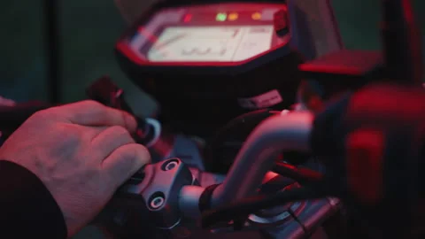 A man accelerates motorcycle, close-up handlebar, outdoors, slow-mo, night Stock Footage 255295514