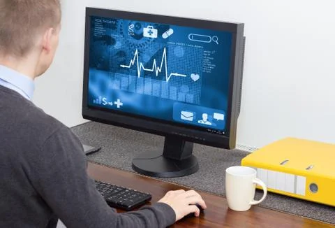 Man accessing medical data on computer Stock Photos