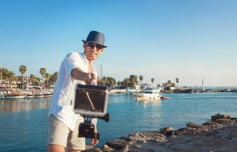 Man with action camera take a selfie photo in the tropical sea bay Stock Photos