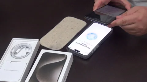 A man activates a purchased smartphone. Transferring information from an ol.. Stock Footage 277481553