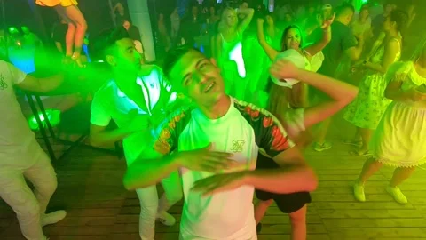 A man is actively dancing and posing for the camera at a disco Video stock 144343989