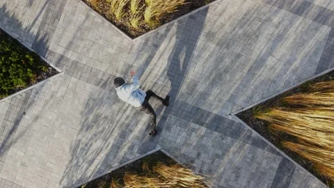 A man is actively dancing breakdancing against the background of wheat and Stock Footage 164914519