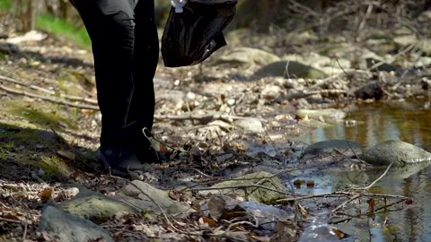 Man activist clean up plastic waste in a river Stock Footage 236903239