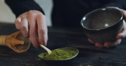 Man add matcha green tea powder into bowl. Matcha Organic Green Tea. Matcha Tea Stock Footage 126370696