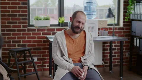 Man with addiction having nervous breakdown in front of people at aa group Stock Footage 165336072
