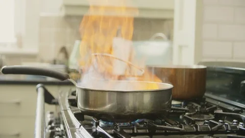 Man Adding Alcohol And Cooking Food In Flambe Style Stock Footage 86077829