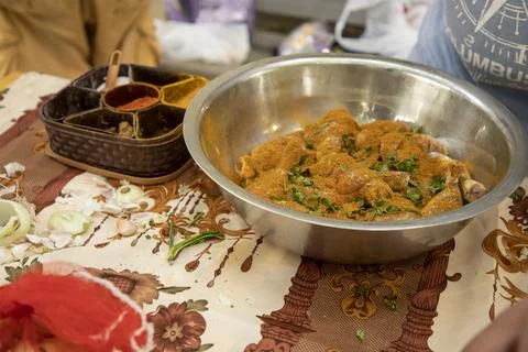 A man adding all masala in chicken Stock Photos